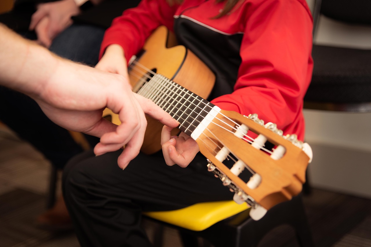 toddler taking guitar class with instructor